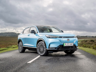 Front quarter view of Honda e:Ny1 parked across a country road Front quarter view of Honda e:Ny1 parked across a country road