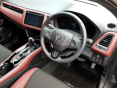 The Honda HR-V Sport features a sporty two-tone red and black interior