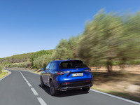 A blue Honda ZR-V drives away