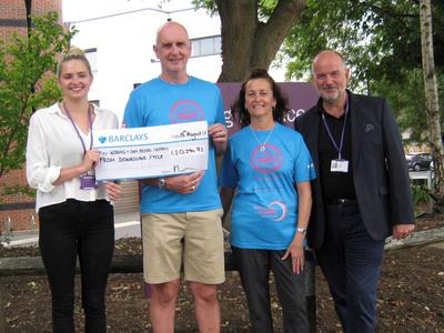 Downslink Challenge hands cheque for £10,294.83 to Woking & Sam Beare Hospices