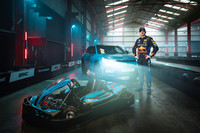 Max Verstappen stands between the all-new Honda e-Ny1 and a racing gokart