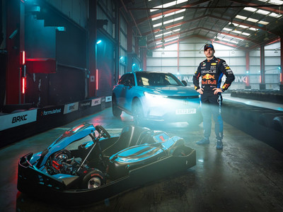 Max Verstappen stands between the all-new Honda e:Ny1 and a racing go-kart