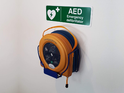 Our new defibrillator in its place on our reception wall